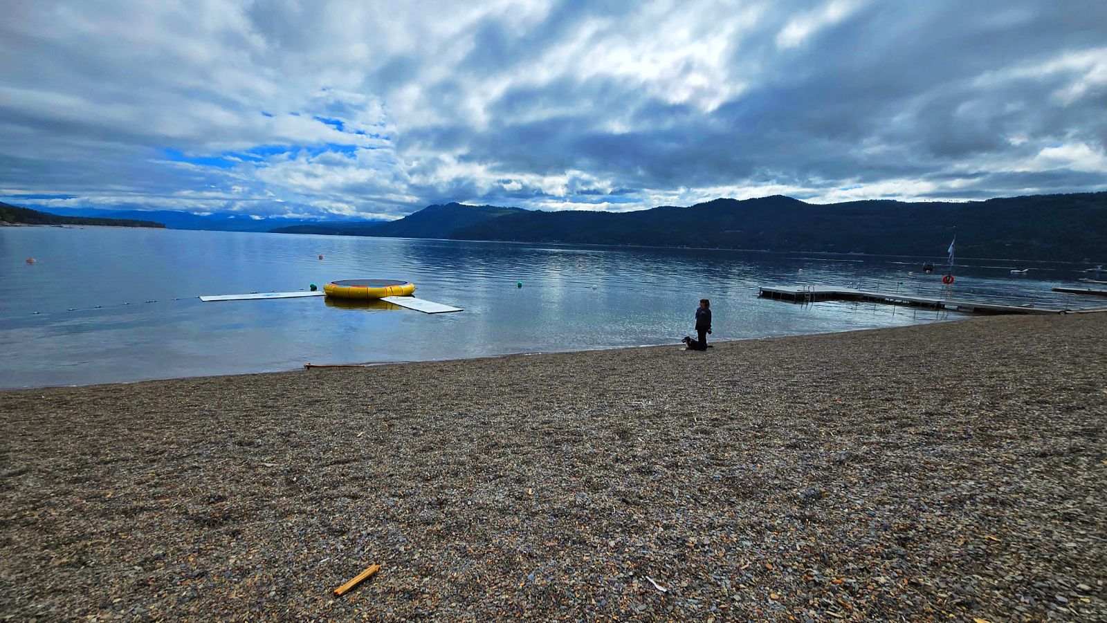 The resort's private pebble beach with dock, swim platform and water trampoline
