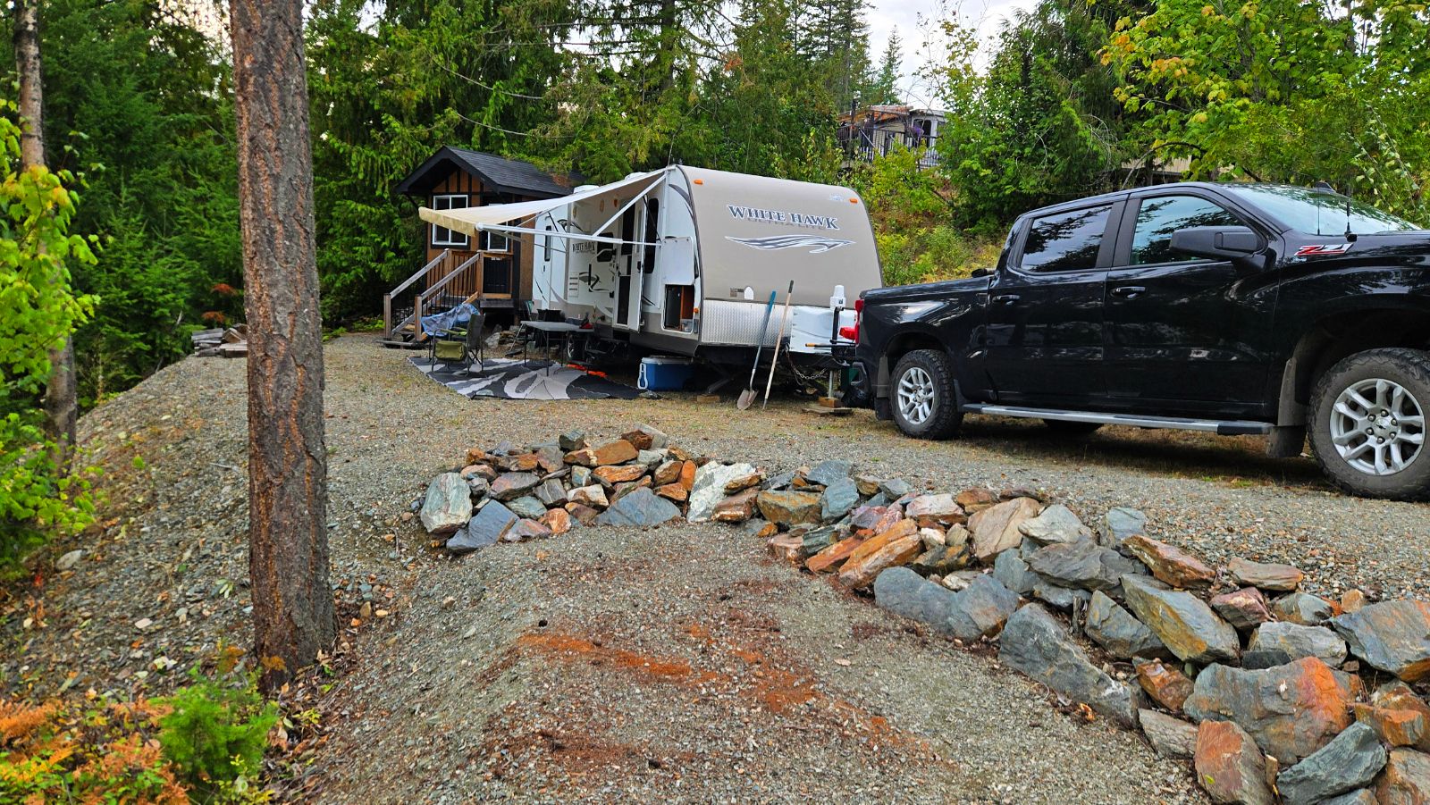 Trailer and truck set up on Lot 117 beside the bunkhouse